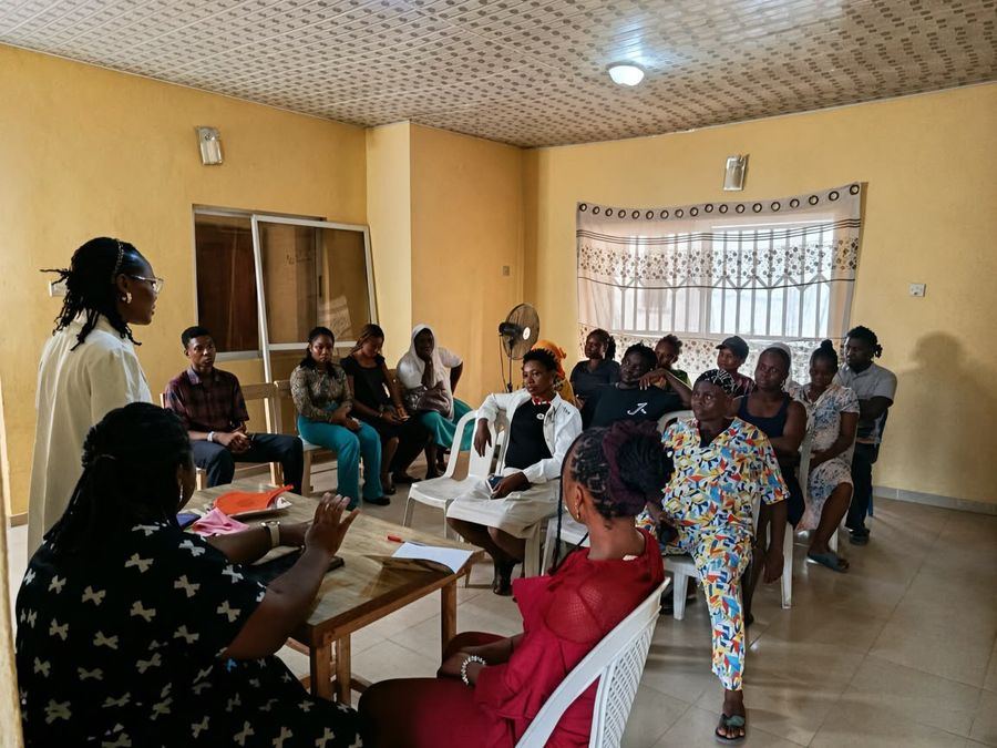 Parents seated at a parent-teacher meeting in the school hall
