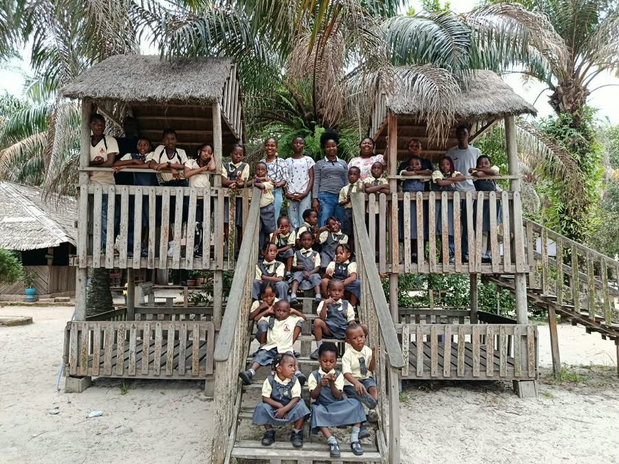 Pupils in uniform on a tree-house platform during an excursion