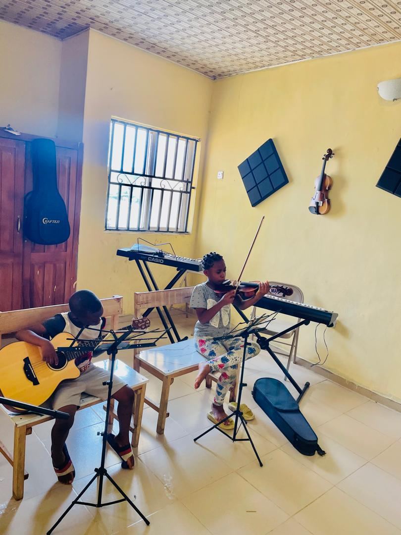 Pupils practising guitar and violin in Music Club