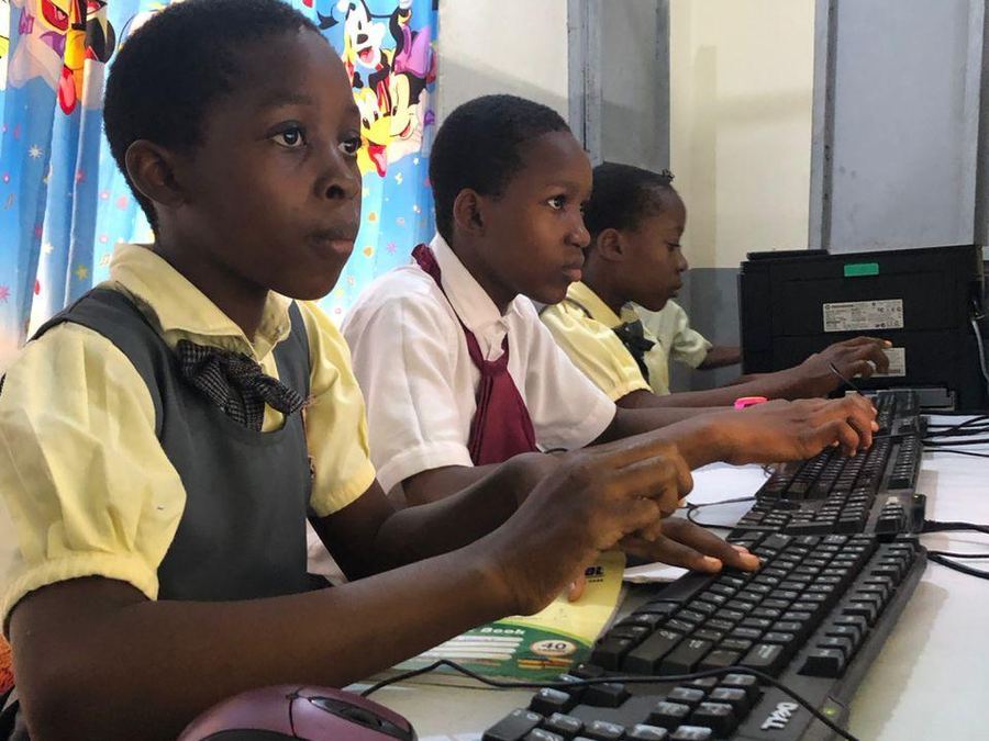 Pupils typing at computers during an ICT lesson