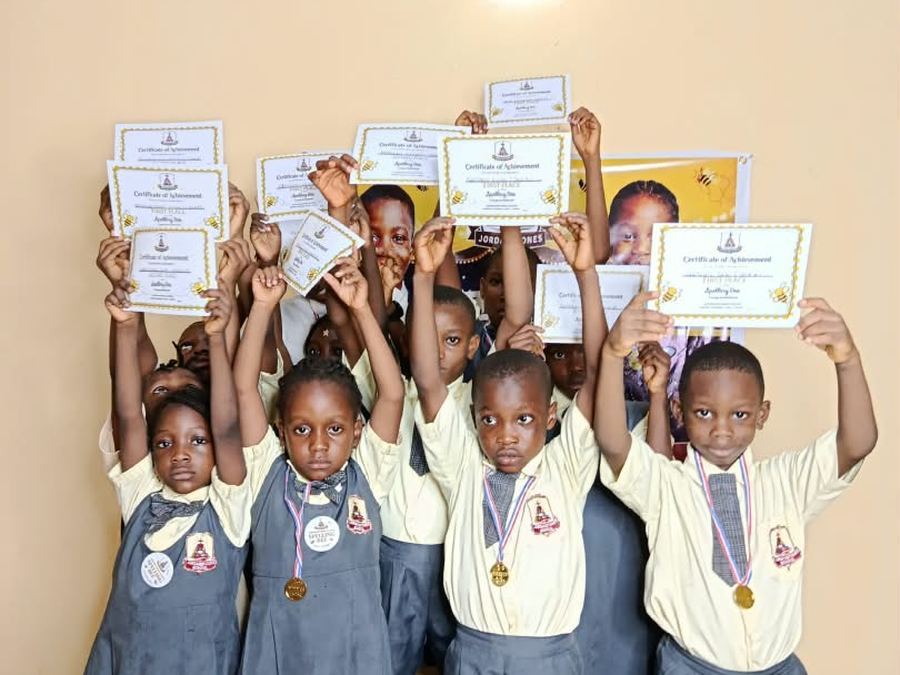 Spelling Bee winners holding up their certificates