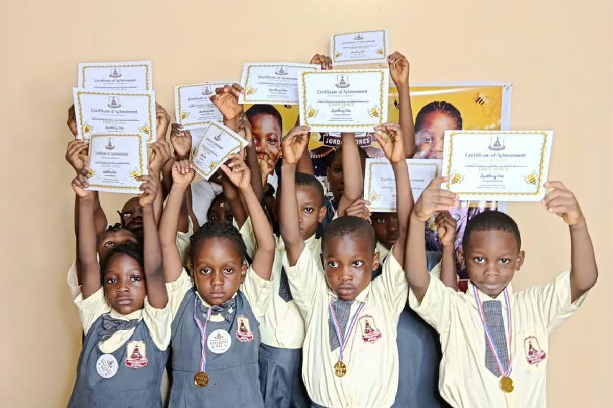 Spelling Bee winners holding up their certificates and medals