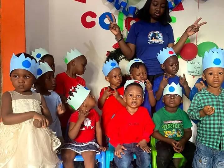 Young pupils in paper crowns on Colour Day